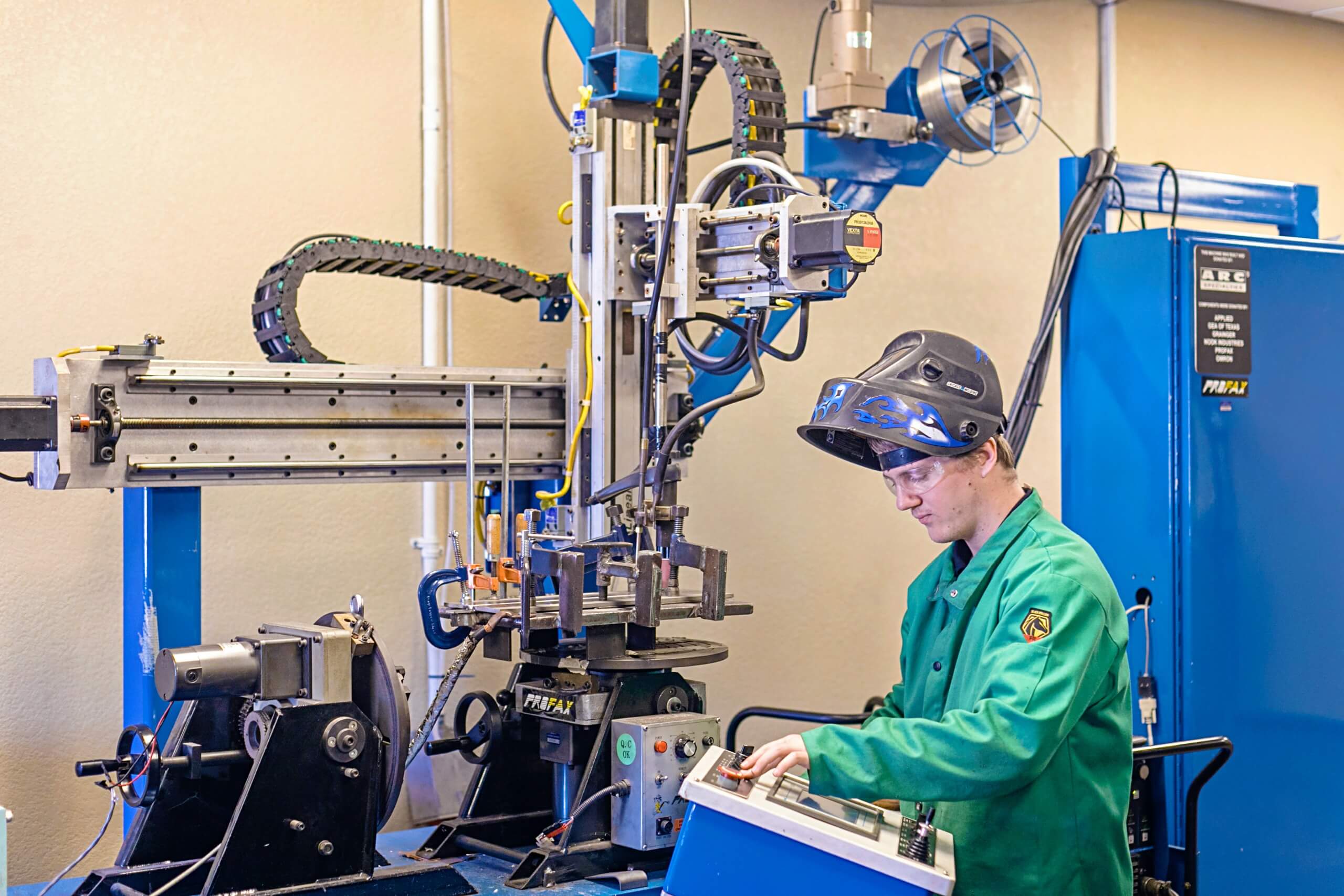 A welding engineering student uses welding lab machinery