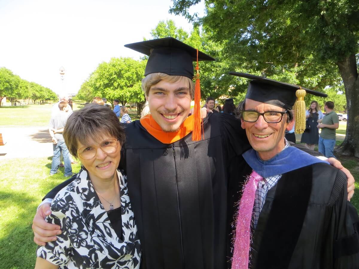 Josh Brake poses with Dr. and Mrs. Graff at graduation.